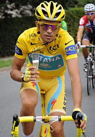 Alberto Contador partakes in a celebratory sip of bubbly en route to Paris.