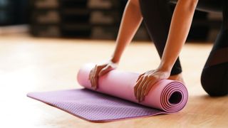 How to get fit: Image shows person rolling yoga mat