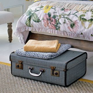 Bedroom with a suitcase on the floor at the foot of the bed