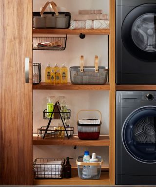 laundry accessories such as bottles of detergent and towels hidden behind wooden sliding doors