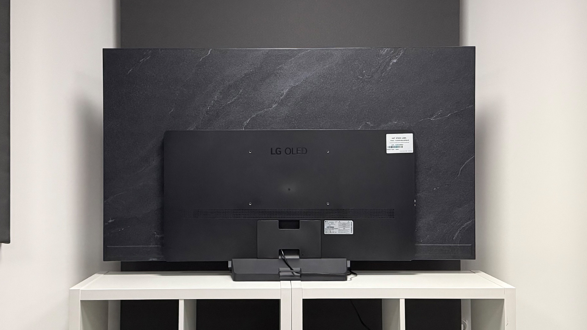 LG C6 OLED TV on white shelving unit, rear of TV set