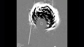 A gray scale image shows a plume of energy coming from the center of the image