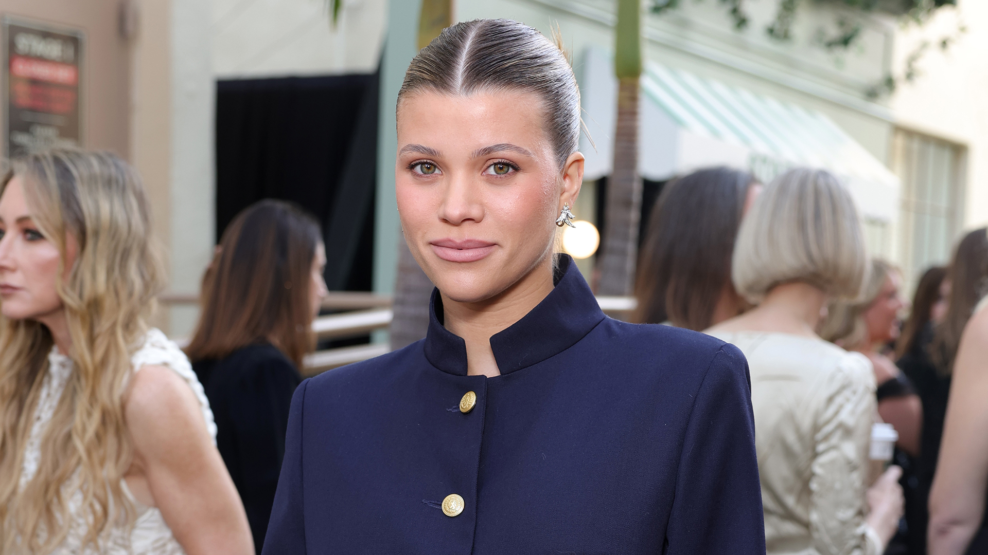 Sofia Richie wearing a navy coat, jeans, and black pumps and Vogue World in Hollywood