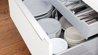 picture of open drawers with organised dishware and utensils