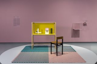 Exhibition vignette on a checkered rug by Wieki Somers