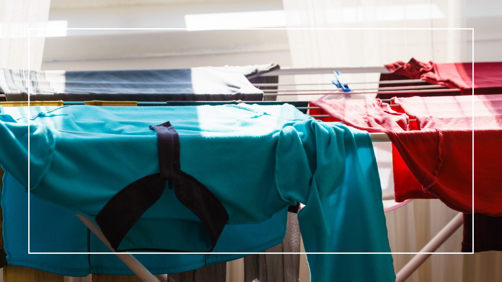  picture of airer in front of window with clothes on top of it