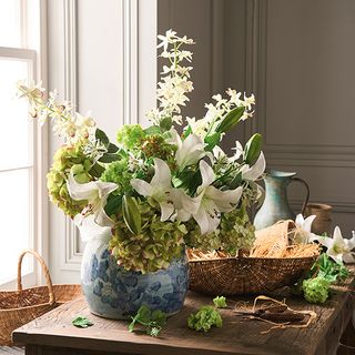 blue flower vase on wooden table and baskets