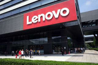  People walk by the Lenovo Group Ltd. headquarters in Beijing,