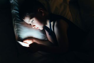 child using a smartphone possibly in an abusive situation