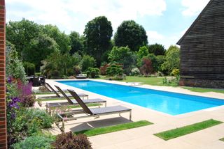 an outdoor swimming pool by a self build house