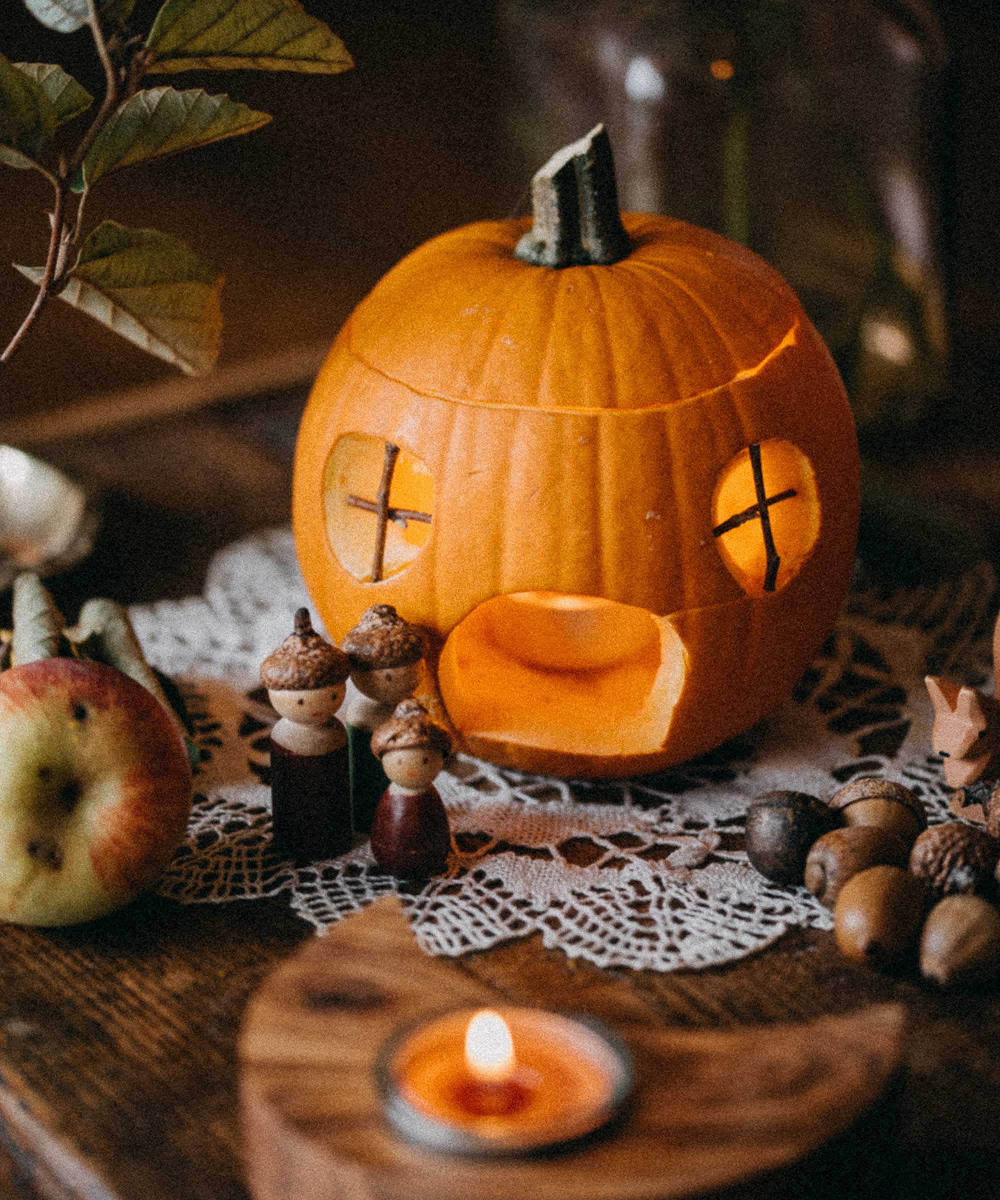 carved pumpkin house on table