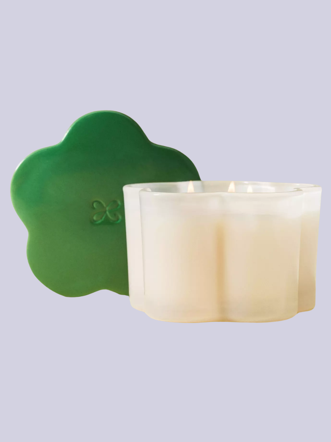 A glass scented candle with a green lid from Maeve