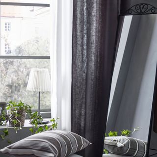room with grey curtains and plants