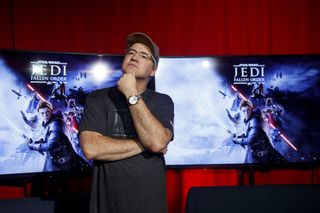 Vince Zampella strikes a thinking pose in front of Star Wars: Jedi Fallen Order art.