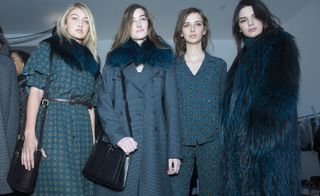 4 Models wearing shades of blue winter and fur coats, dresses and pyjamas