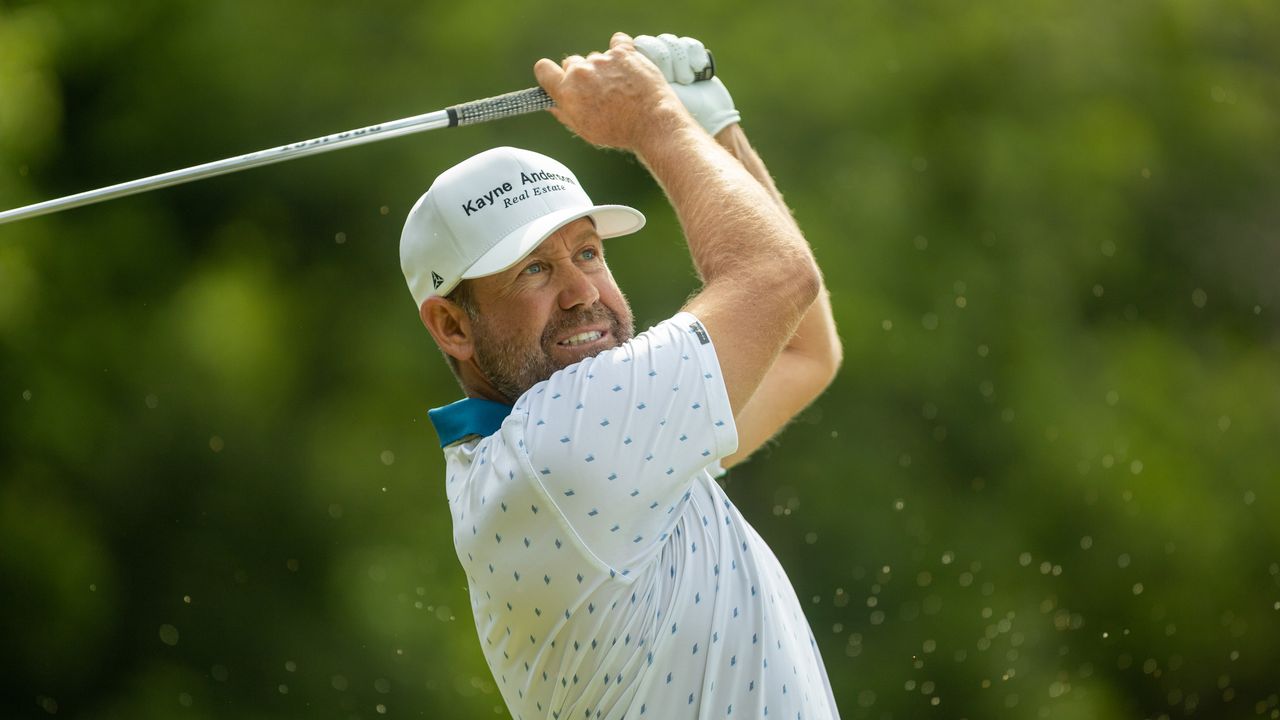 Erik Compton plays a golf iron shot