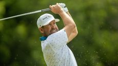 Erik Compton plays a golf iron shot