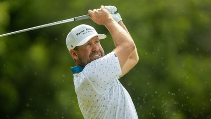 Erik Compton plays a golf iron shot