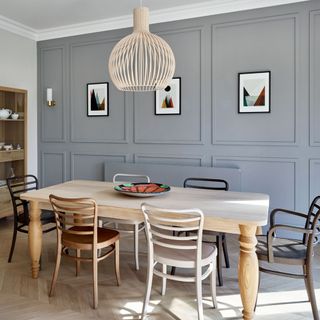 Dining room with light wooden table and chairs and grey walls