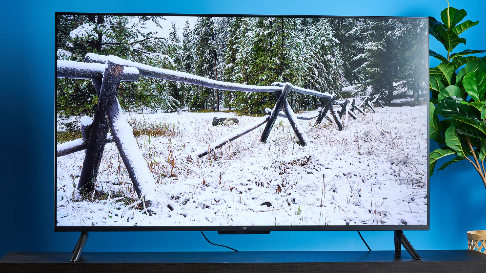 the amazon ember 4-series TV photographed against the blue tom's guide background