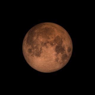 The Moon takes on a reddish hue during a lunar eclipse.