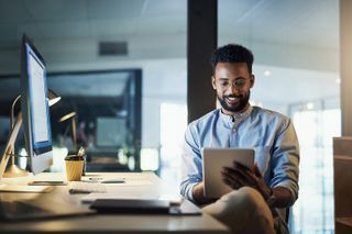 man using a tablet in an office