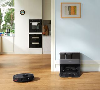 roborock s7 max ultra by the empty wash full dock in an open plan living room kitchen