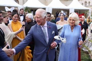 King Charles and Queen Camilla shaking hands with well-wishers