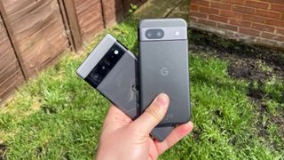 Google Pixel 8a and Google Pixel 6 Pro held together over green grass