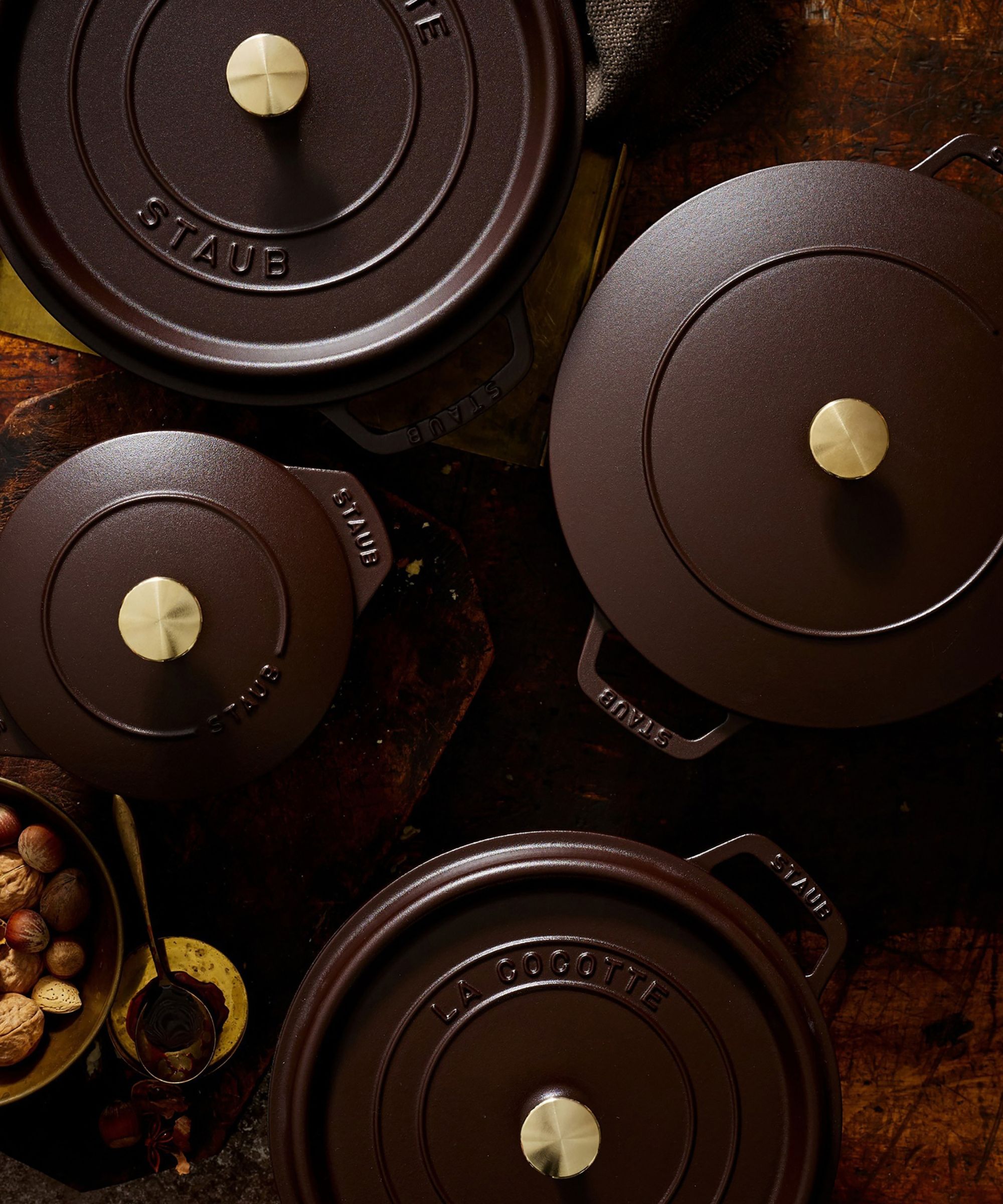 A set of deep brown cast-iron cookware viewed from above.