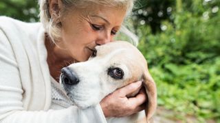 Woman kissing her dog