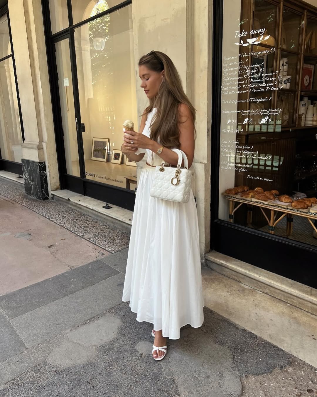 @lovisabarkman wears a white button-up top, white maxi skirt, white bag and white heeled sandals