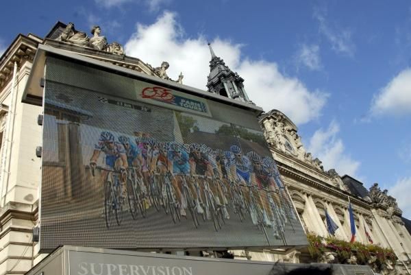 The big screen shows the race's approach.