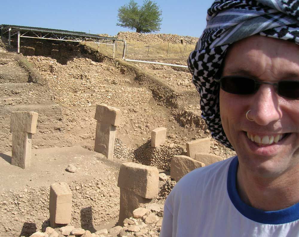 Professor Tristan Carter is shown alongside one of the stone rings at Gobekli Tepe in Turkey.