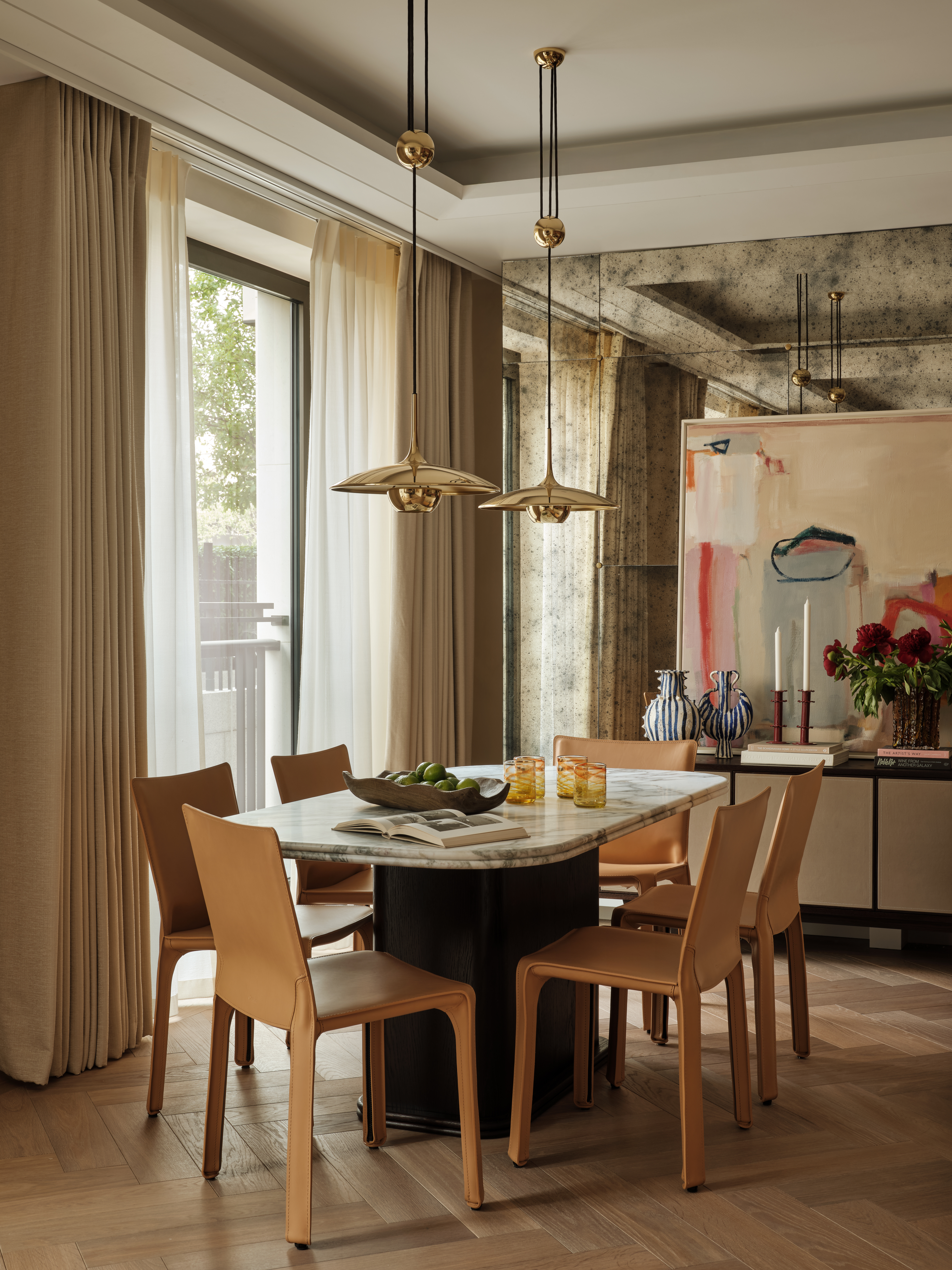 Contemporary dining room with marble table and leather chairs
