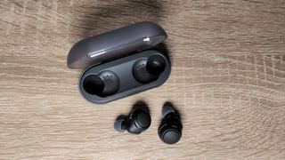 Sony WF-C500 review: headphones on a wooden table
