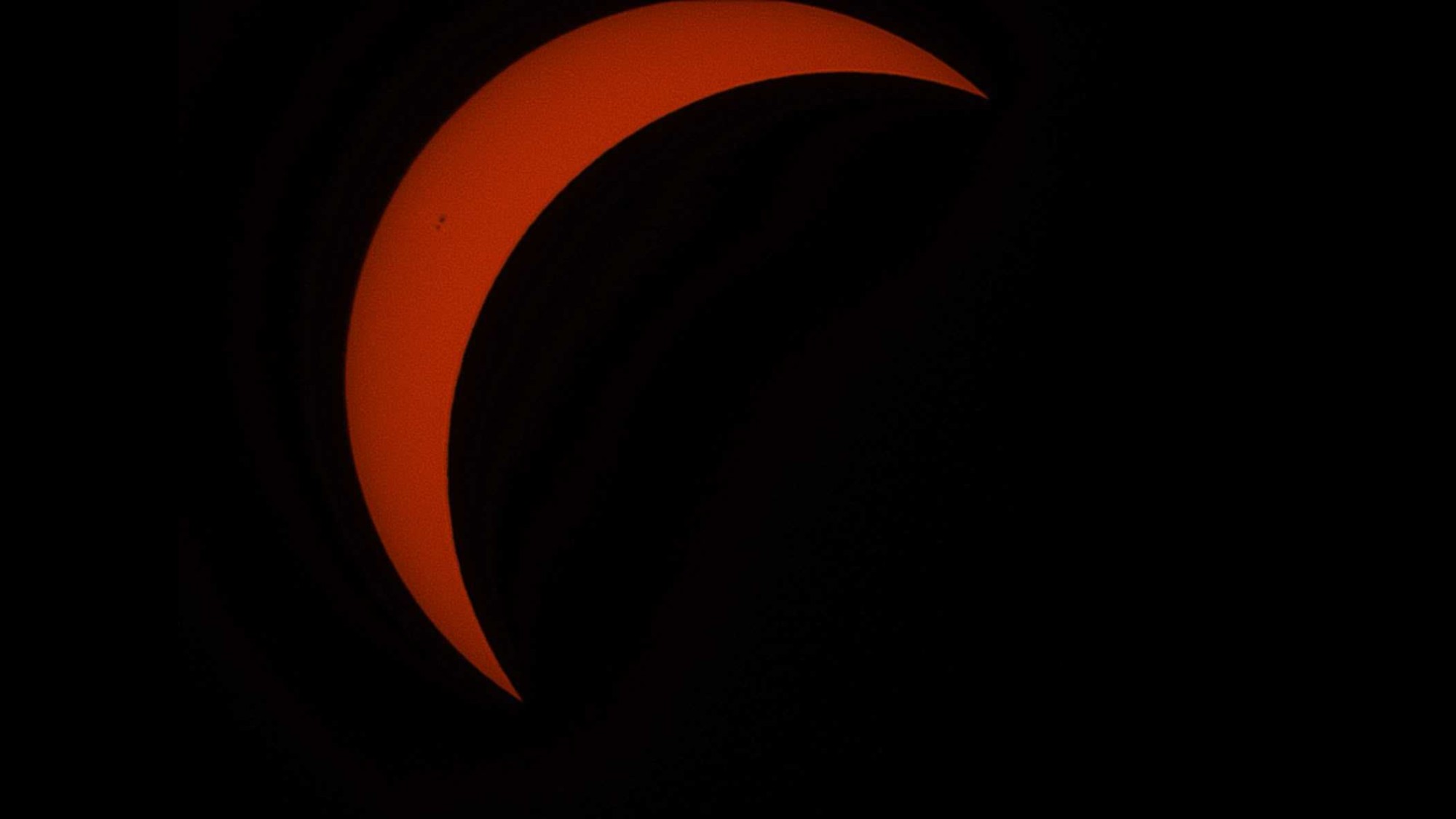 a red crescent on a black background