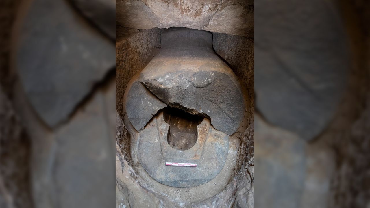 Remains of the sarcophagus are seen here. It was robbed in antiquity and the mummy is gone. The top is broken open and there are hieroglyphs inscribed on the rest of the sarcophagus .