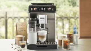 De'Longhi Eletta Explore on the countertop making an iced coffee with cups of coffee around it