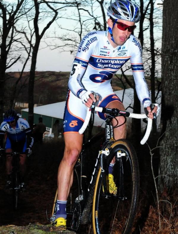 Chris Jones (Champion Systems) riding singletrack ahead of Adam Craig