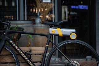 Livall Pikaboost e-bike conversion kit fitted to a bike against a shop window