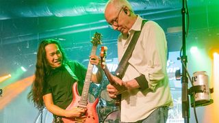 Herman Li and Paul Reed Smith playing guitar onstage
