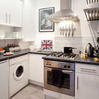 kitchen with white wall and marble kitchen counter and washing machine
