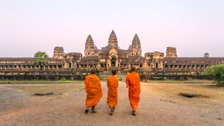Buddhism is a big part of some Eastern cultures. Here, three buddhist monks walking to Angkor Wat temple.