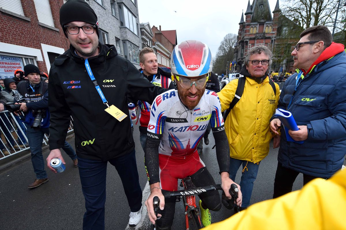 Luca Paolini (Katusha) gets ushered to the podium after his win