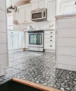 A modern kitchen with flooring stencilled to create a tiled effect