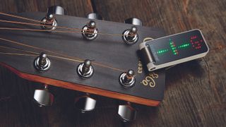 TC Electronic Polytune clip-on tuner on a Martin acoustic guitar headstock