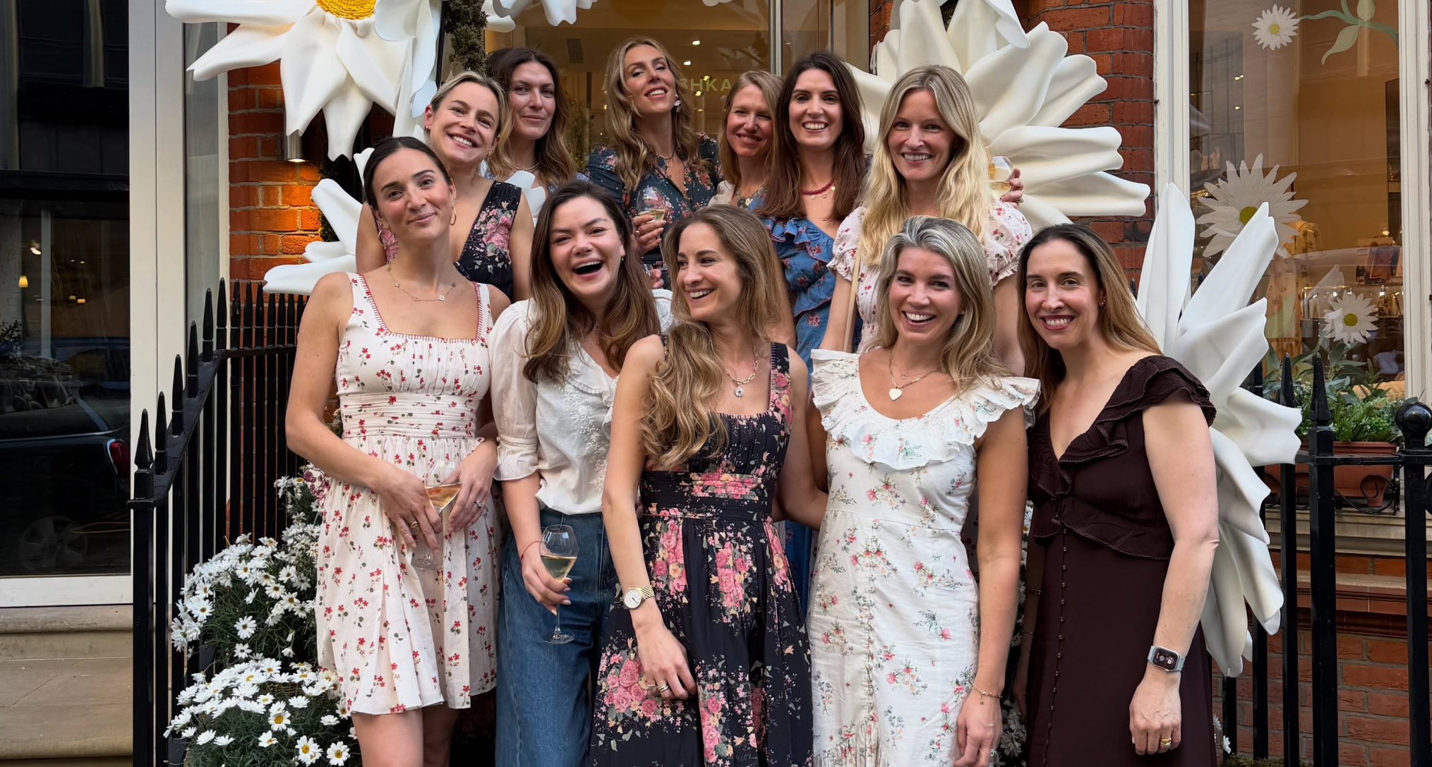 Natasha Archer and a group of women posing in front of a store