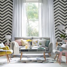 living room with white and black wall sofa with designed cushion