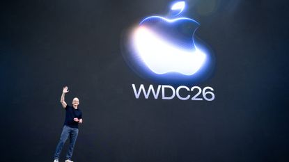 Apple CEO making a peace sign with his fingers while standing on stage at the company's Worldwide Developer Conference (WWDC) at at Apple Park in Cupertino, California.